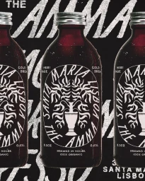 Three glass cold brew bottles featuring bold circular white typography against a dark textured background