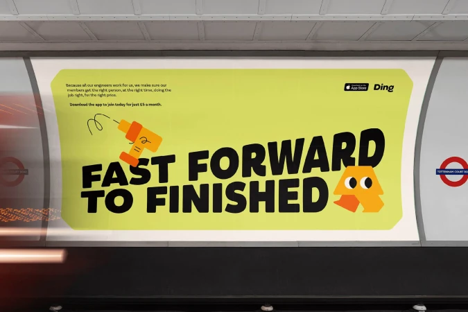 Eye-level shot of an advertisement in the London Underground featuring large text and cartoon graphics, promoting a job application.