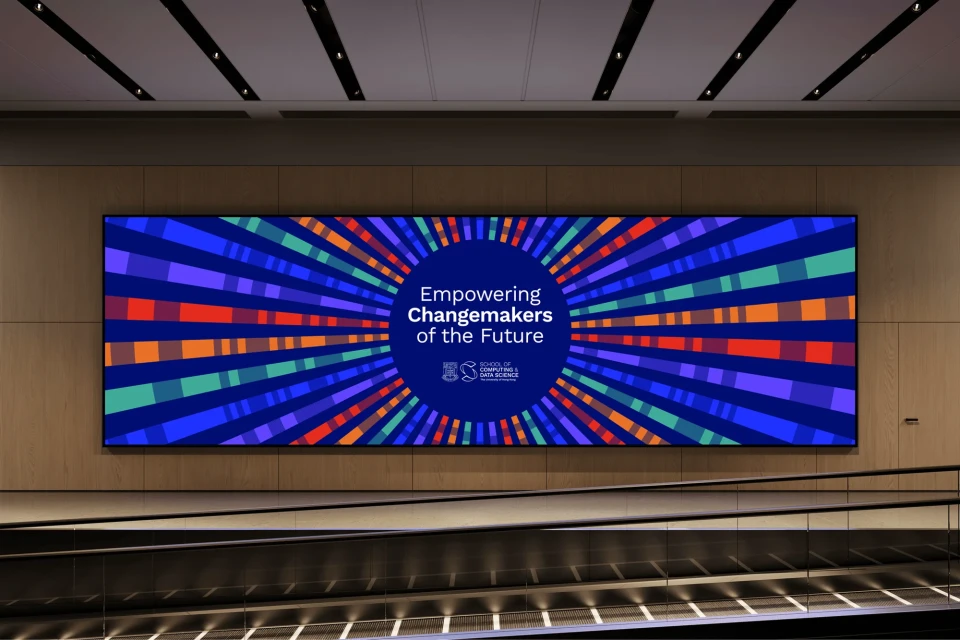 Eye-level indoor shot of a colorful display that reads 'Empowering Changemakers of the Future' with a school of data science logo.
