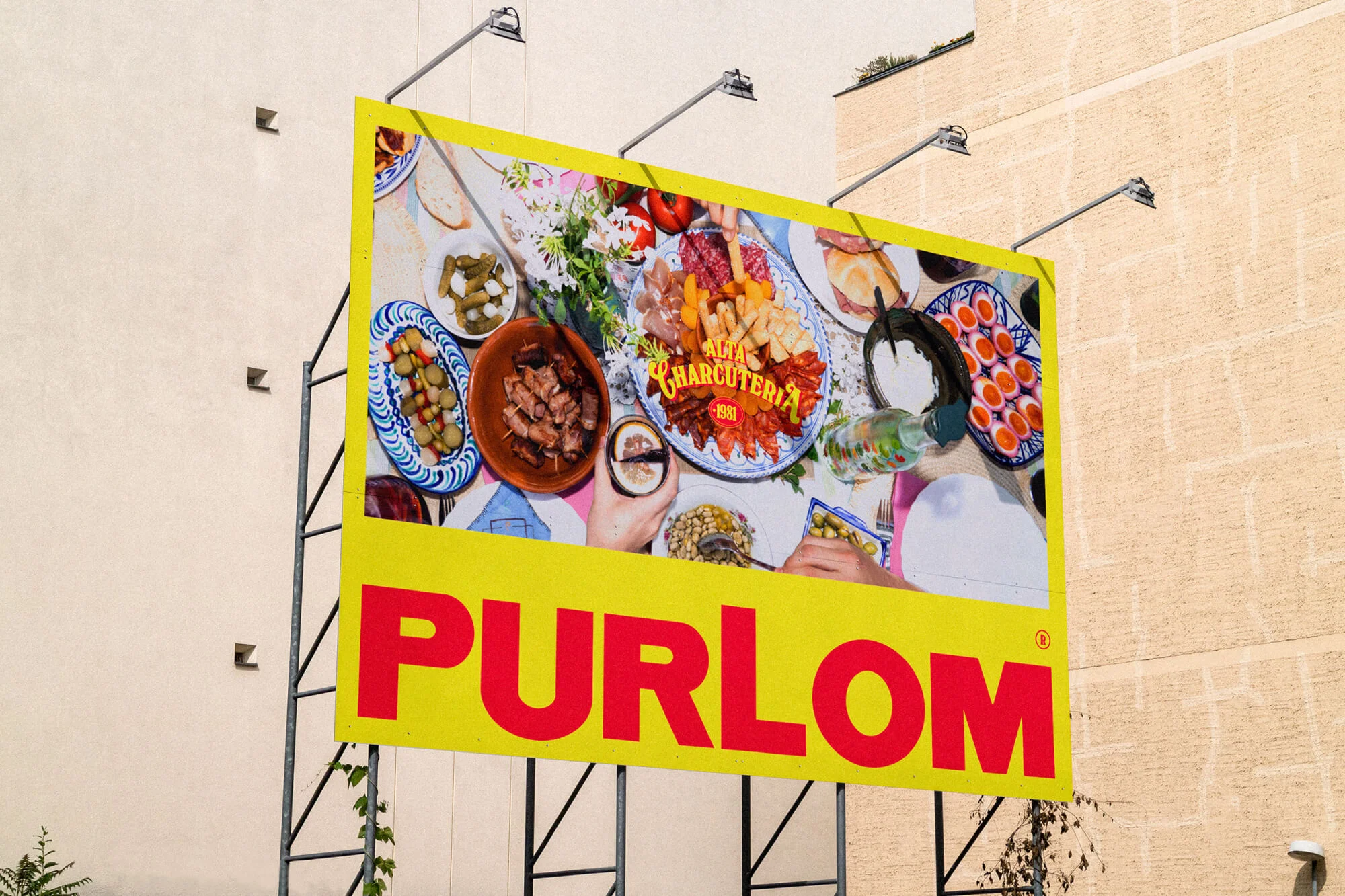 Outdoor billboard advertisement for Purlom featuring a charcuterie board with various meats, cheeses, olives, and other appetizers on plates.