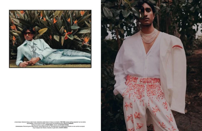 Editorial shot of two South Asian adult males in floral-patterned or light-colored suits, captured in a lush outdoor setting with natural light.