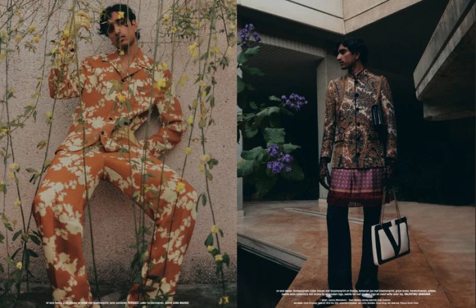 Editorial fashion shot of a man in a floral suit leaning against a wall with flowers, and another man in a paisley suit standing outside.