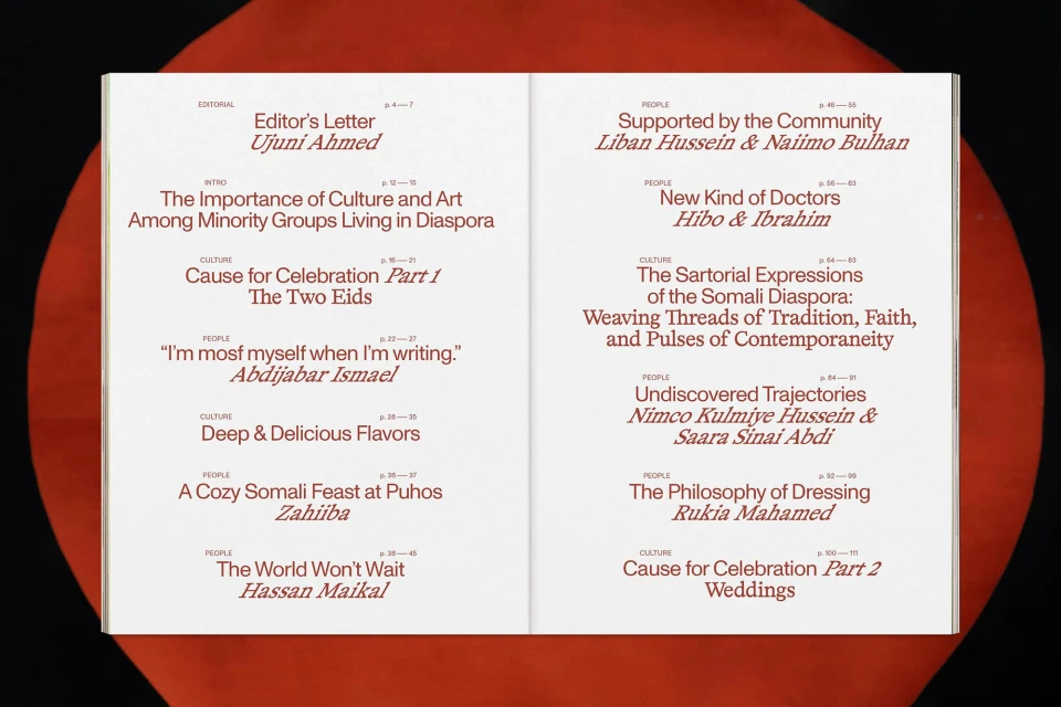 Open magazine spread featuring editorial and people sections, articles in English, and a bold red and black background element.