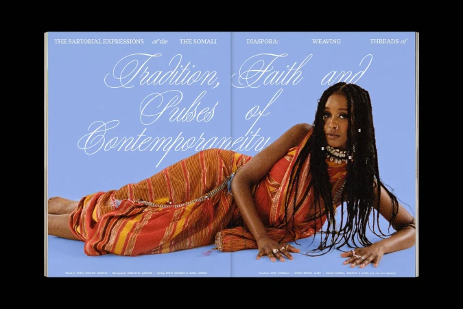 Magazine cover featuring a Somali woman in traditional dress, lying down against a light blue backdrop, showcasing sartorial expressions.