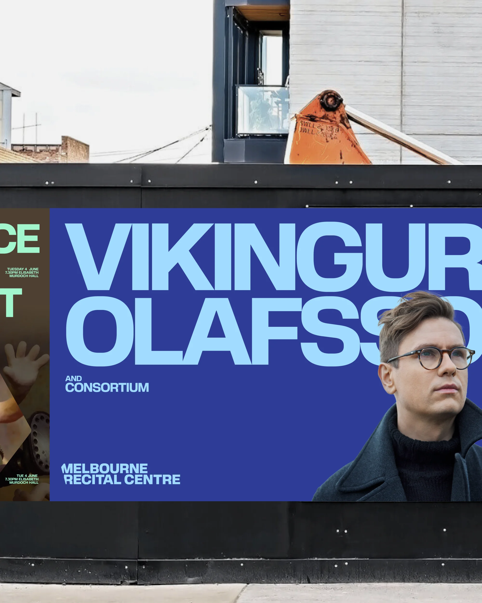 Concert advertisement featuring a portrait of Vikingur Olafsson set against a vibrant blue background on an outdoor billboard.