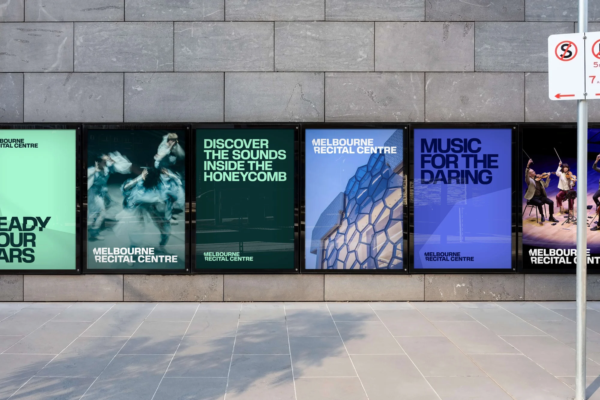 Outdoor posters for the Melbourne Recital Centre featuring music and dance-related themes, displayed on a grey tiled wall in a row.