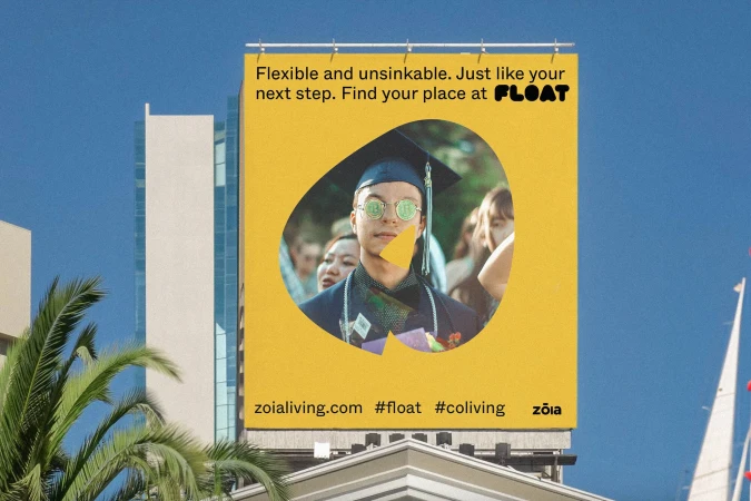 Billboard advertisement featuring a recent graduate in cap and gown, promoting student co-living with the text 'Find your place at FLOAT'.