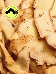 Close-up macro shot of textured light-colored compostable wrap pieces with a bright yellow caterpillar logo sticker