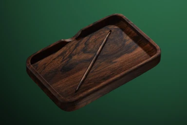 Dark wooden tray with visible grain and a matching stylus resting diagonally against a solid dark green background.