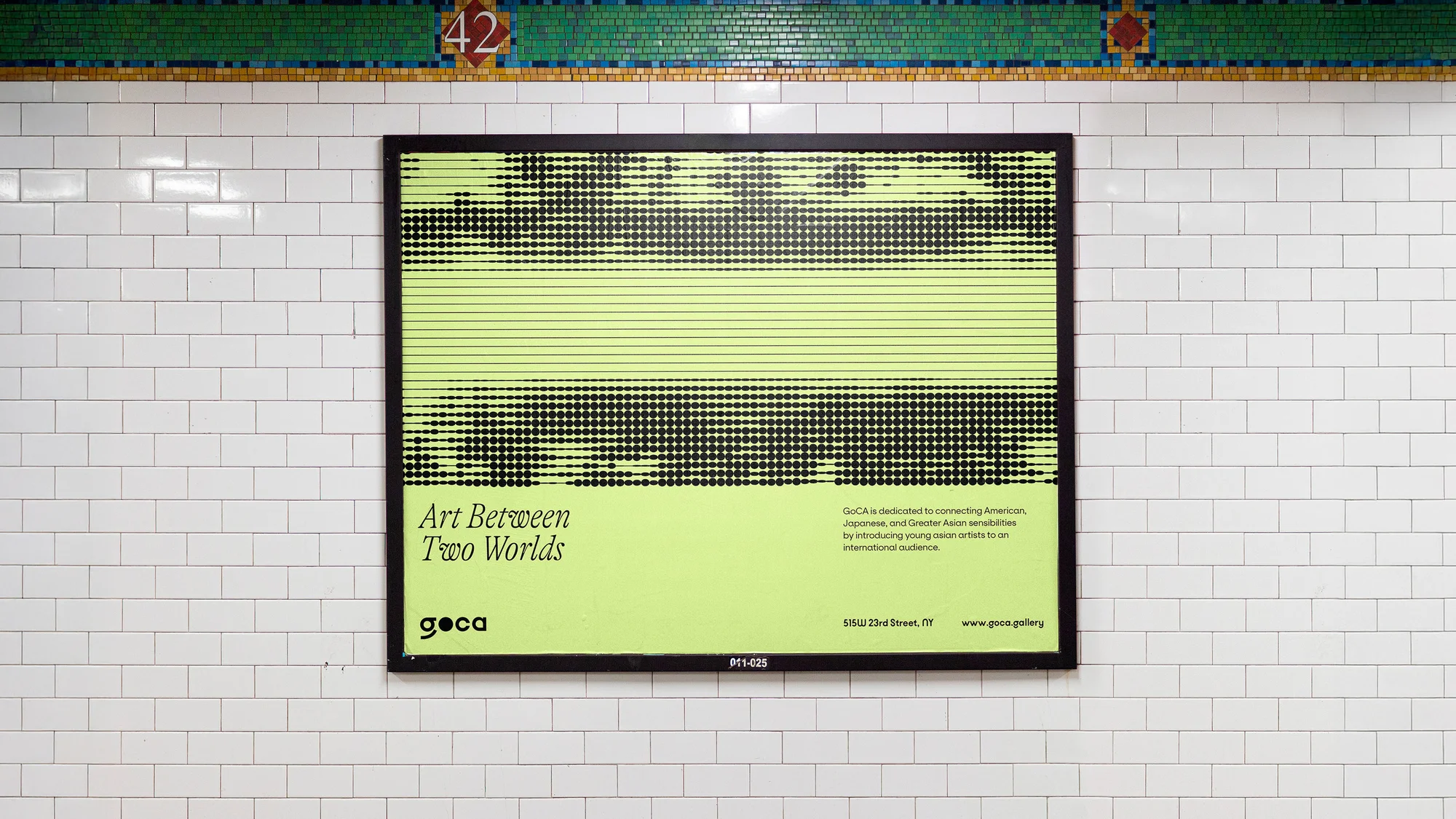 Framed GoCA gallery art exhibition poster on a subway station wall with a green and black design, promoting an art exhibition.