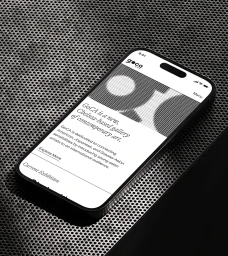 Smartphone displaying a monochrome gallery website interface set against a textured metallic perforated background.