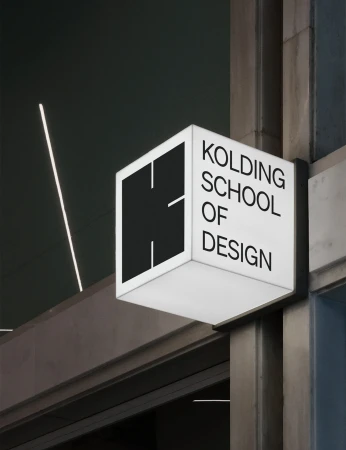 Exterior illuminated signage for Kolding School of Design, featuring a stylized 'K' logo on a modern building facade.