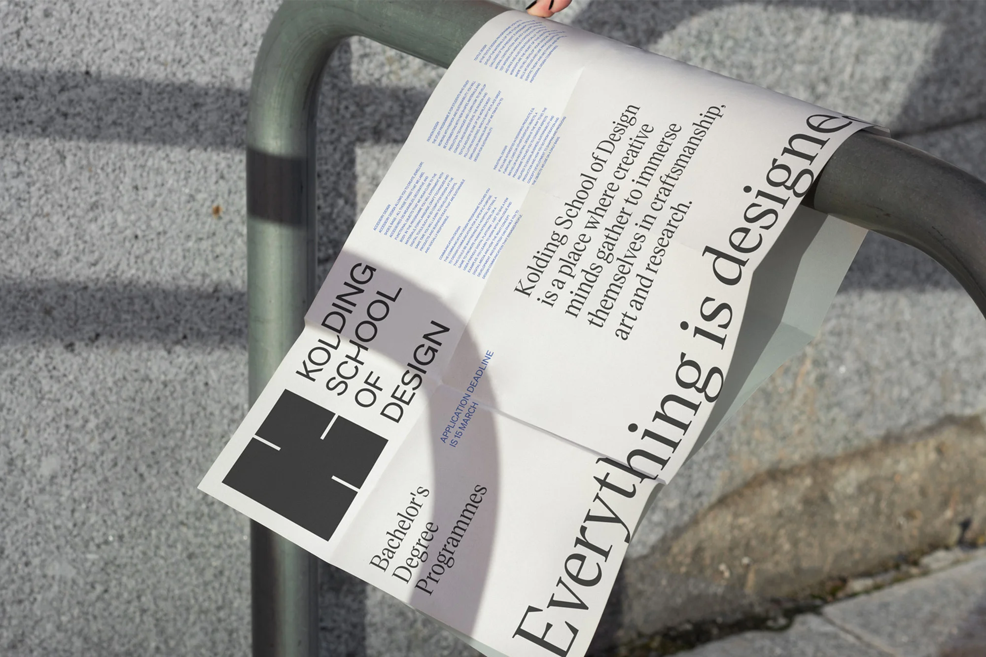 Kolding School of Design advertisement poster attached to a metal railing with an application deadline of March 15th.