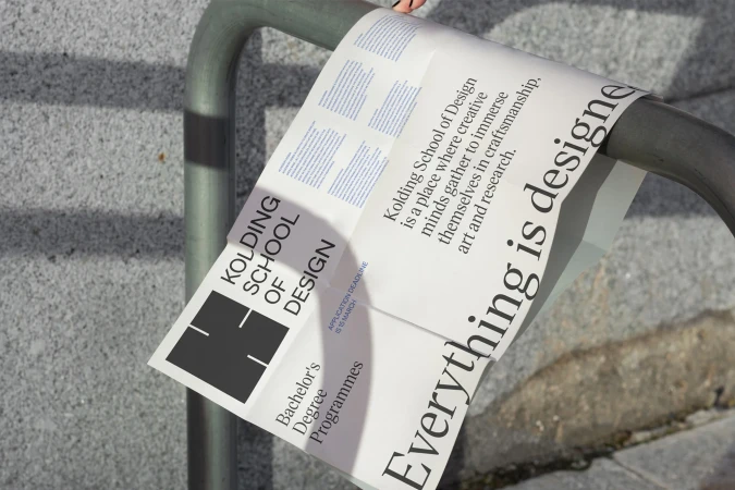 Kolding School of Design advertisement poster attached to a metal railing with an application deadline of March 15th.