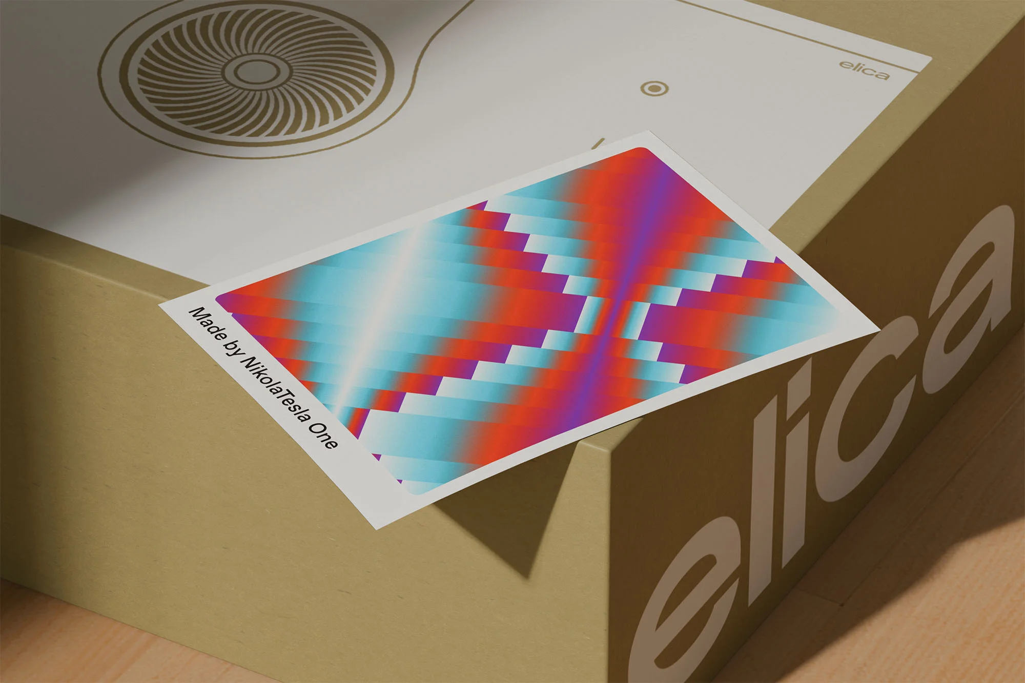 Close-up of a colorful abstract pattern card on top of an appliance box with the brand name Elica on the side.