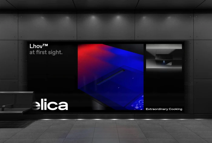 Digital advertisement for Elica displayed on a dark grey tiled wall inside a public transport station