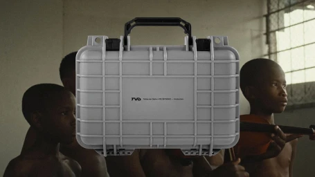 Grey protective equipment case with black handle featuring brand typography, held before children in an interior space
