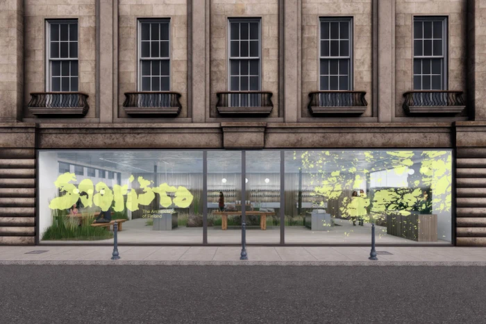 Storefront exterior of Saaristo featuring large glass windows with yellow branding and interior retail displays.