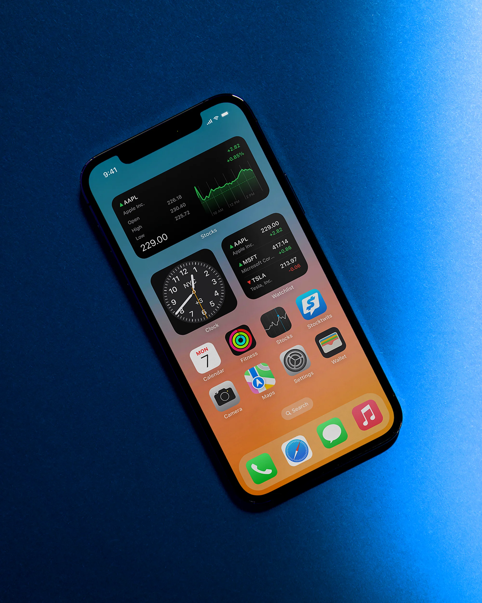 An iPhone displays various app icons and widget information on its screen against a blue background, showcasing modern mobile technology.
