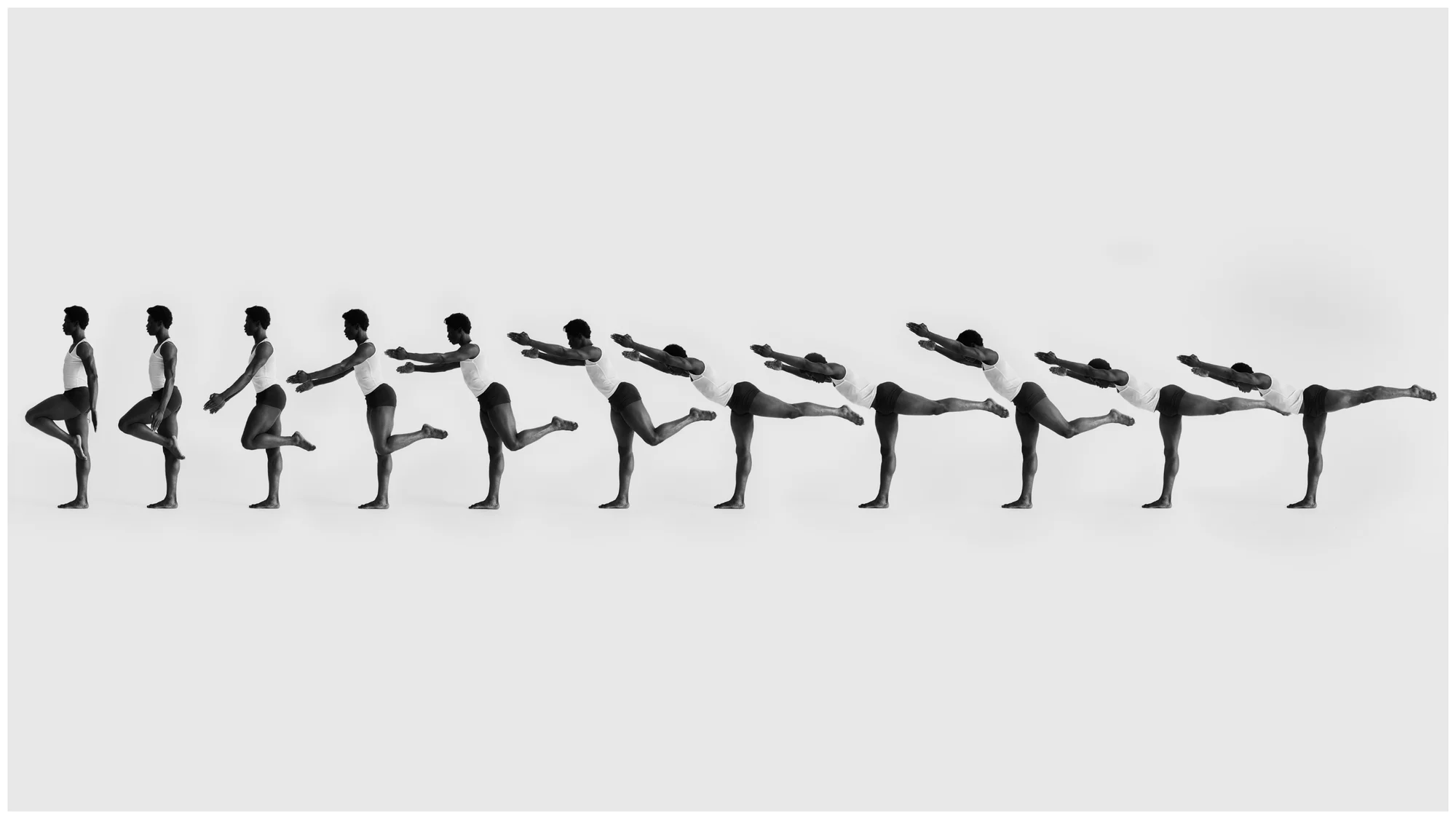 Multiple exposures of a Black adult male in mid-air performing a fitness movement against a white background in a studio setting.