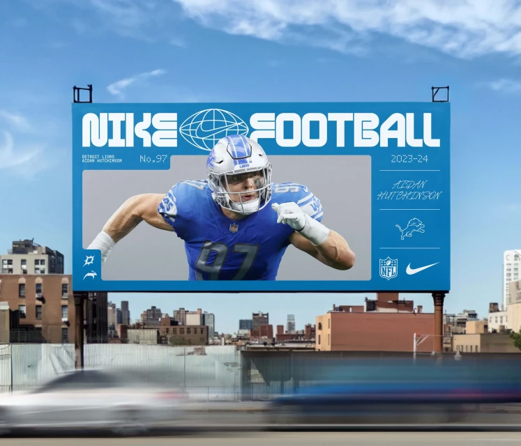 Billboard featuring an American football player in uniform, blue sky and city buildings in the background, promoting Nike football.