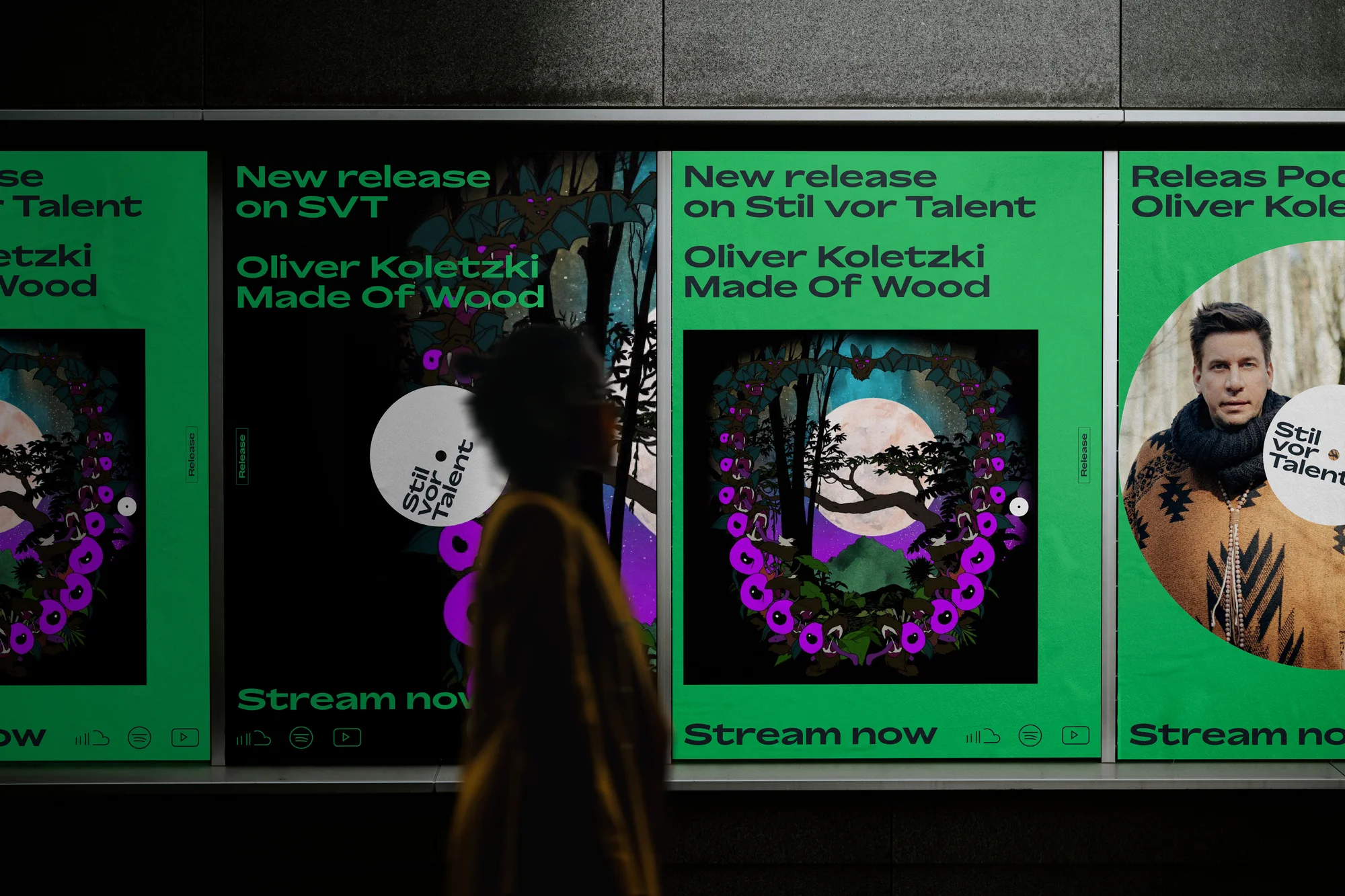 New release advertising posters with music artist Oliver Koletzki's album 'Made of Wood,' seen at a train station platform.