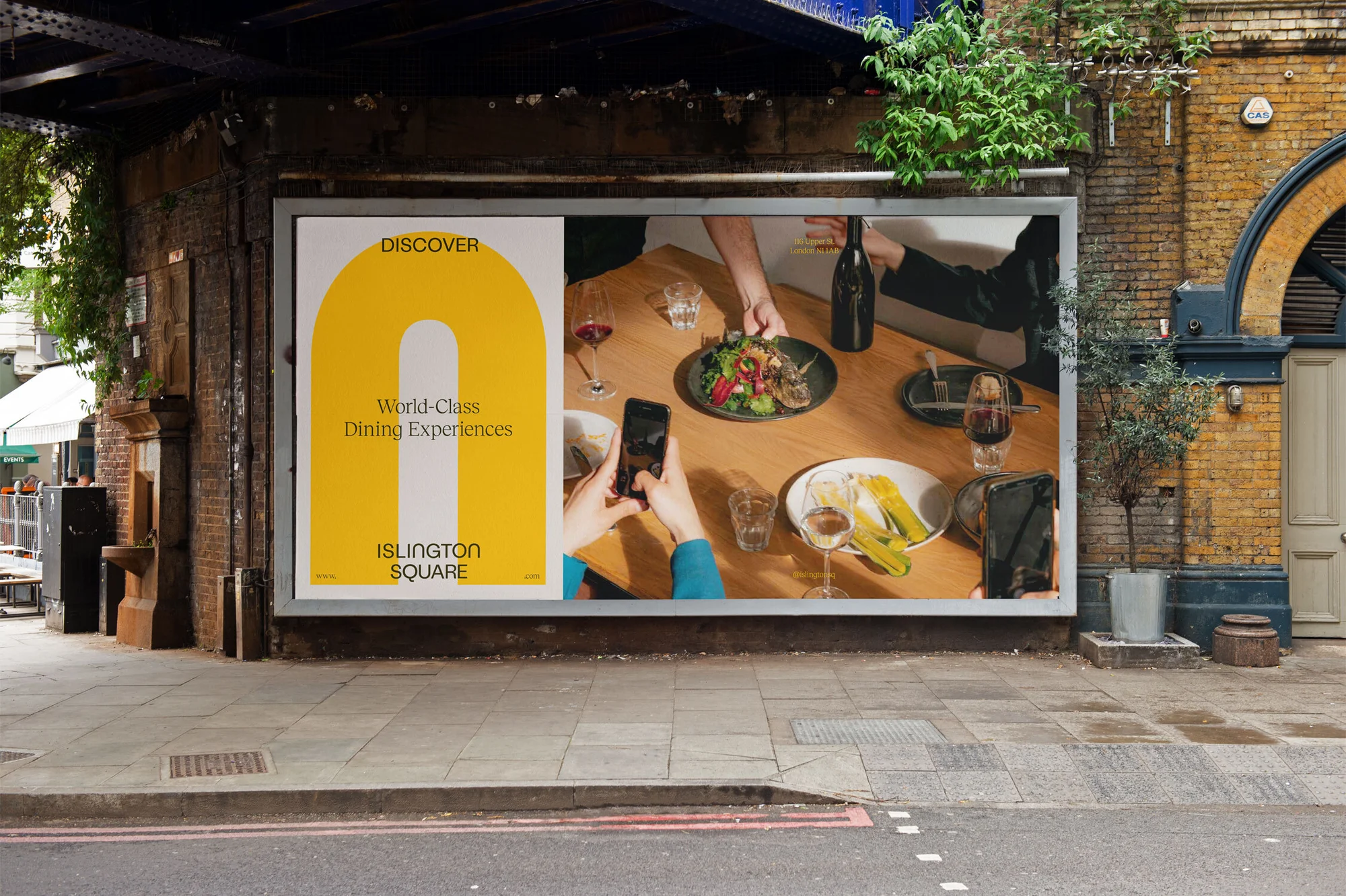 Billboard advertises world-class dining experiences at Islington Square, showing a table with food, drinks, and people taking photos.