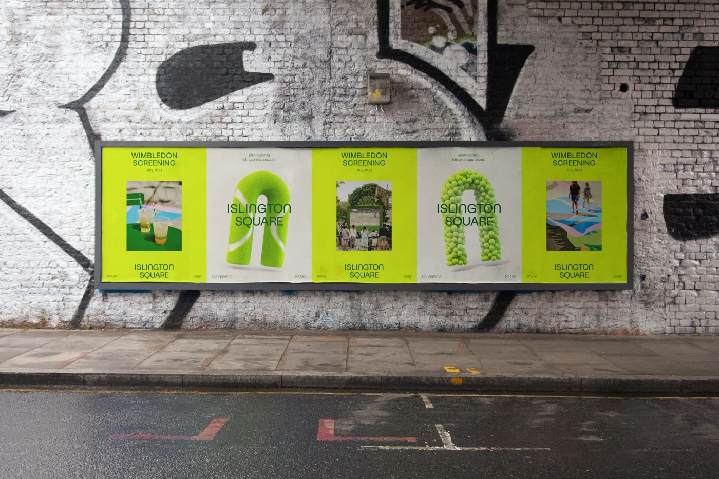 Islington Square brand identity posters mounted on a weathered brick wall above an urban street.