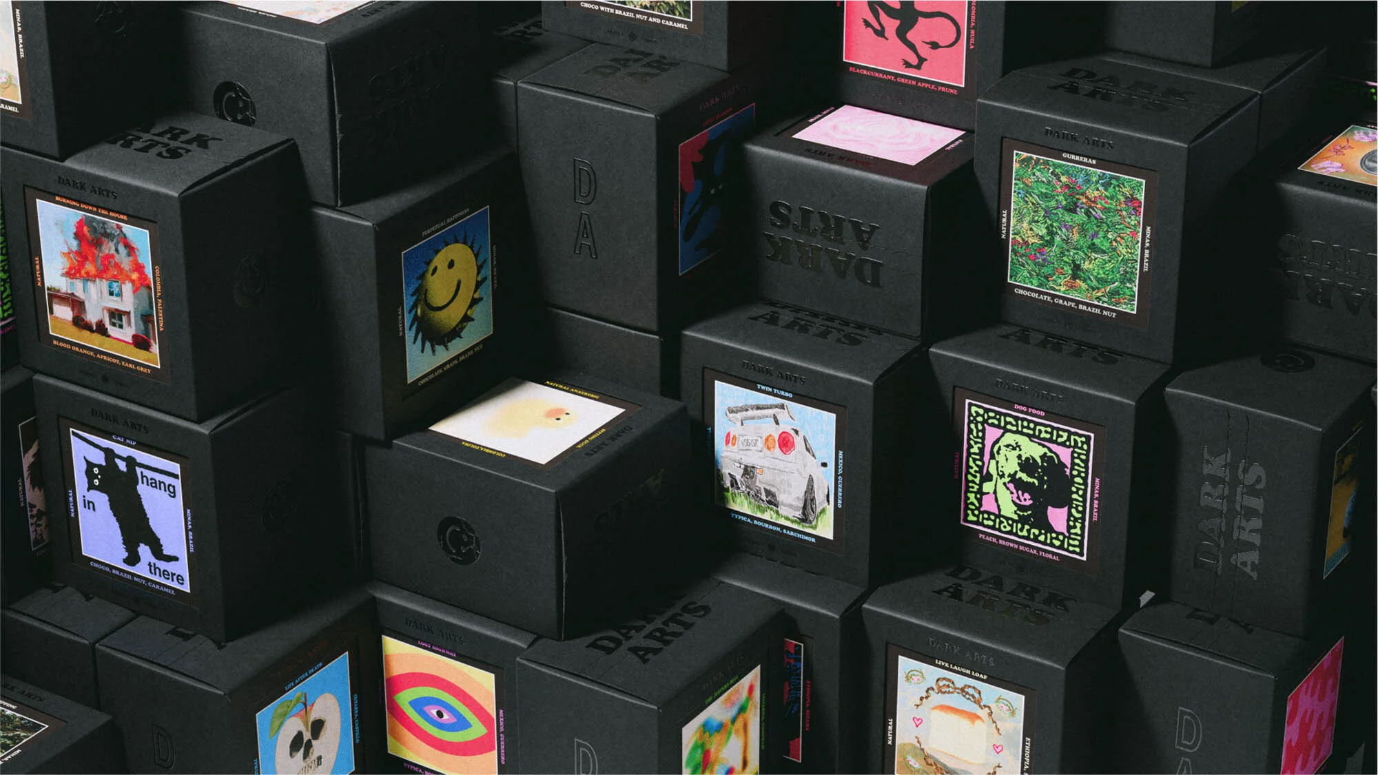 Collection of black boxes with artistic graphics and text labels stacked in an organized manner, creating a visually interesting pattern.