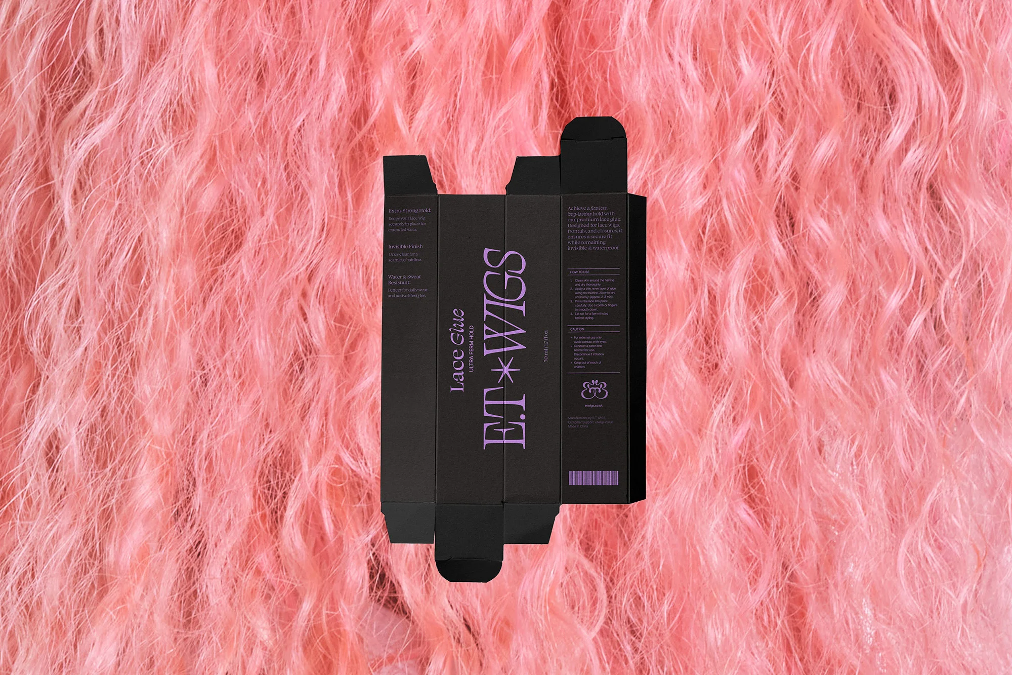 ET Wigs lace glue packaging on a backdrop of pink wavy hair. The box is black with pink text, displayed against a vibrant pink background.