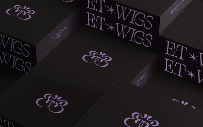 Black packaging boxes with purple branding for E.T WIGS displayed in an arrangement