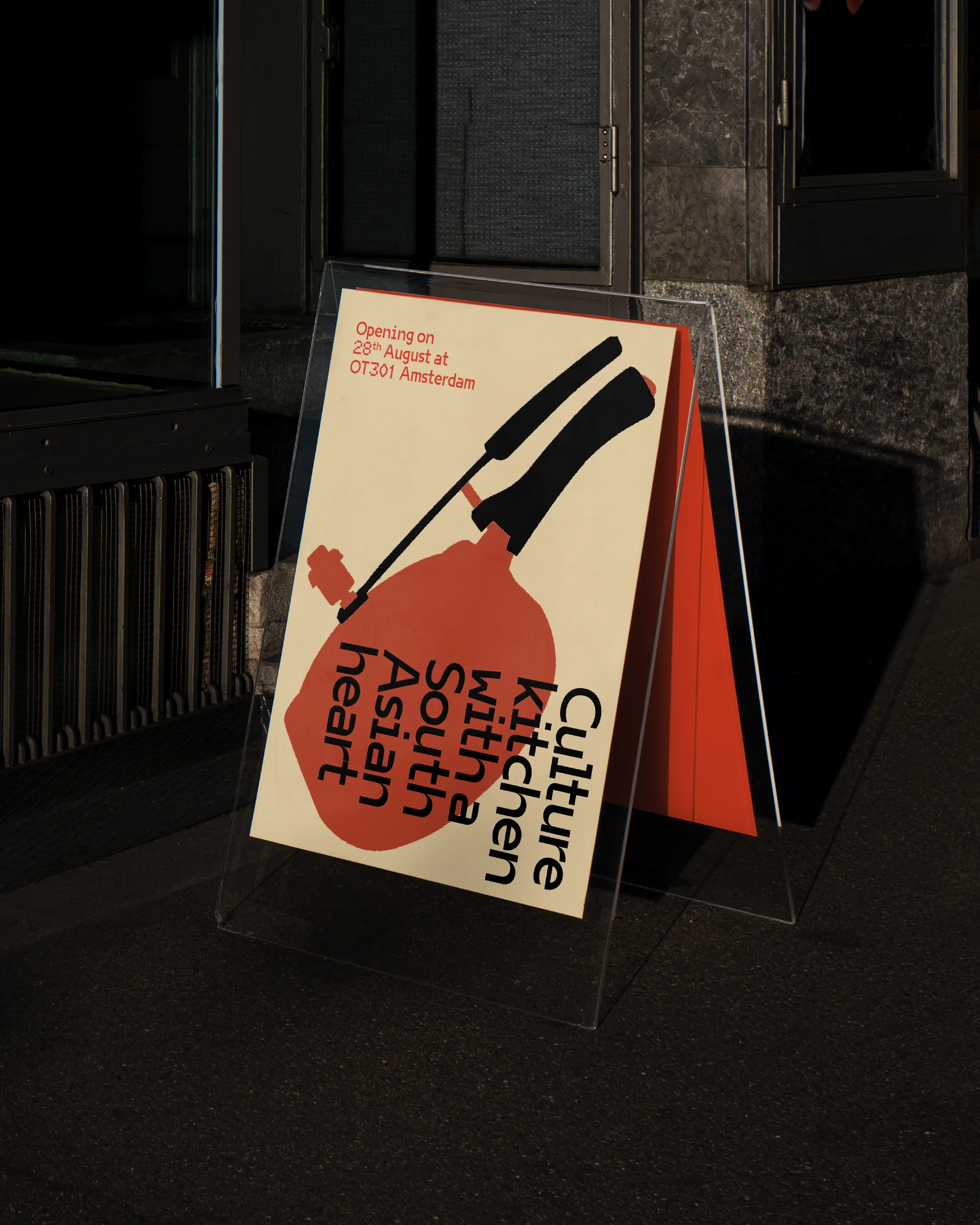 A-frame sign advertises 'Culture Kitchen with a South Asian Heart' in front of a building, featuring an illustration of a cooking pot.