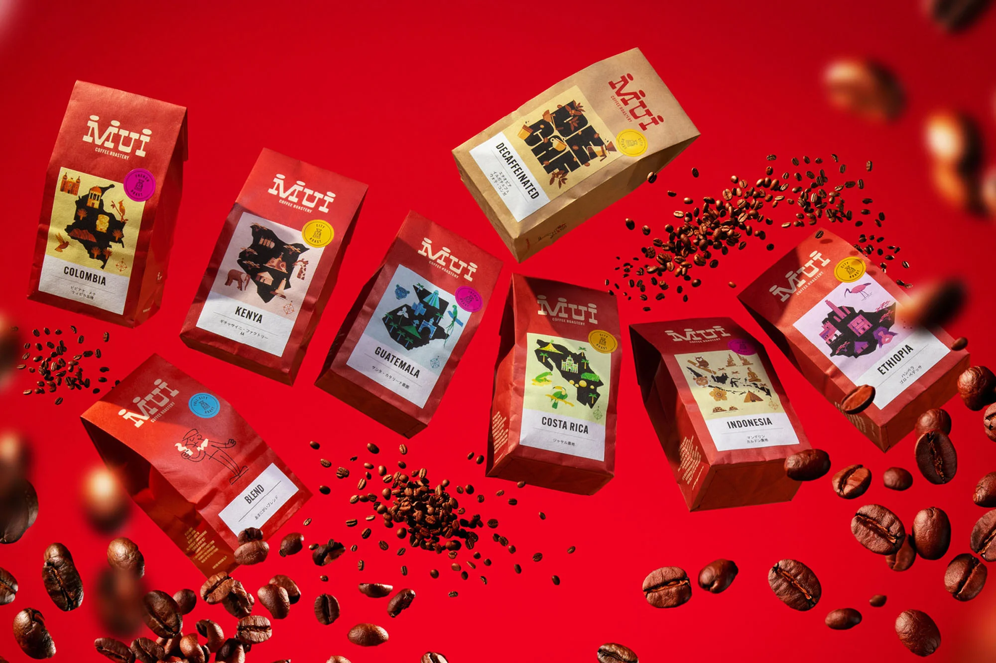 Eight packages of MUI brand coffee beans, with coffee beans scattered on a red background in a product shot advertising coffee.