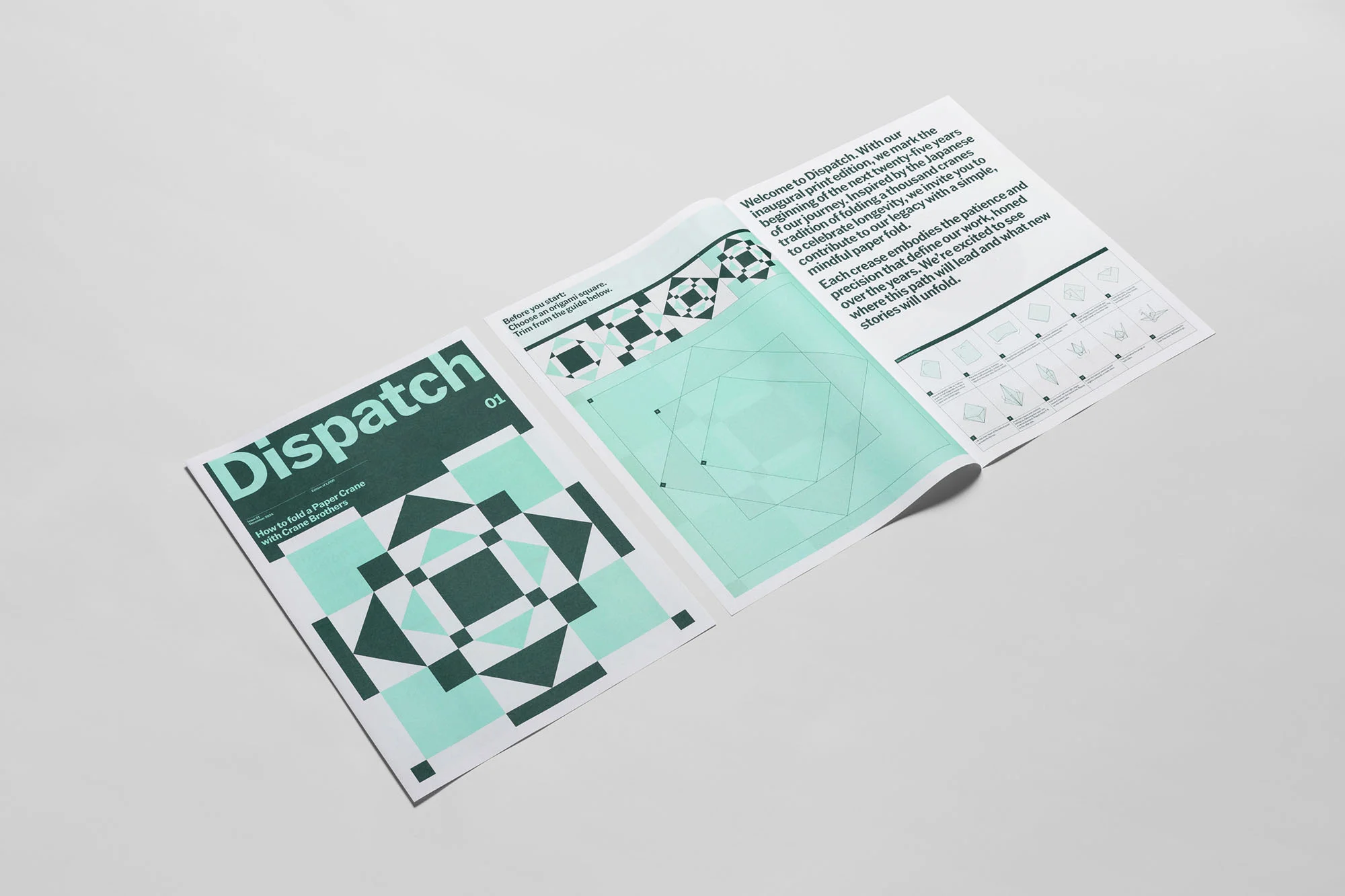 Opened inaugural print edition of Dispatch magazine featuring geometric designs in green and teal, showcasing paper art and typography.