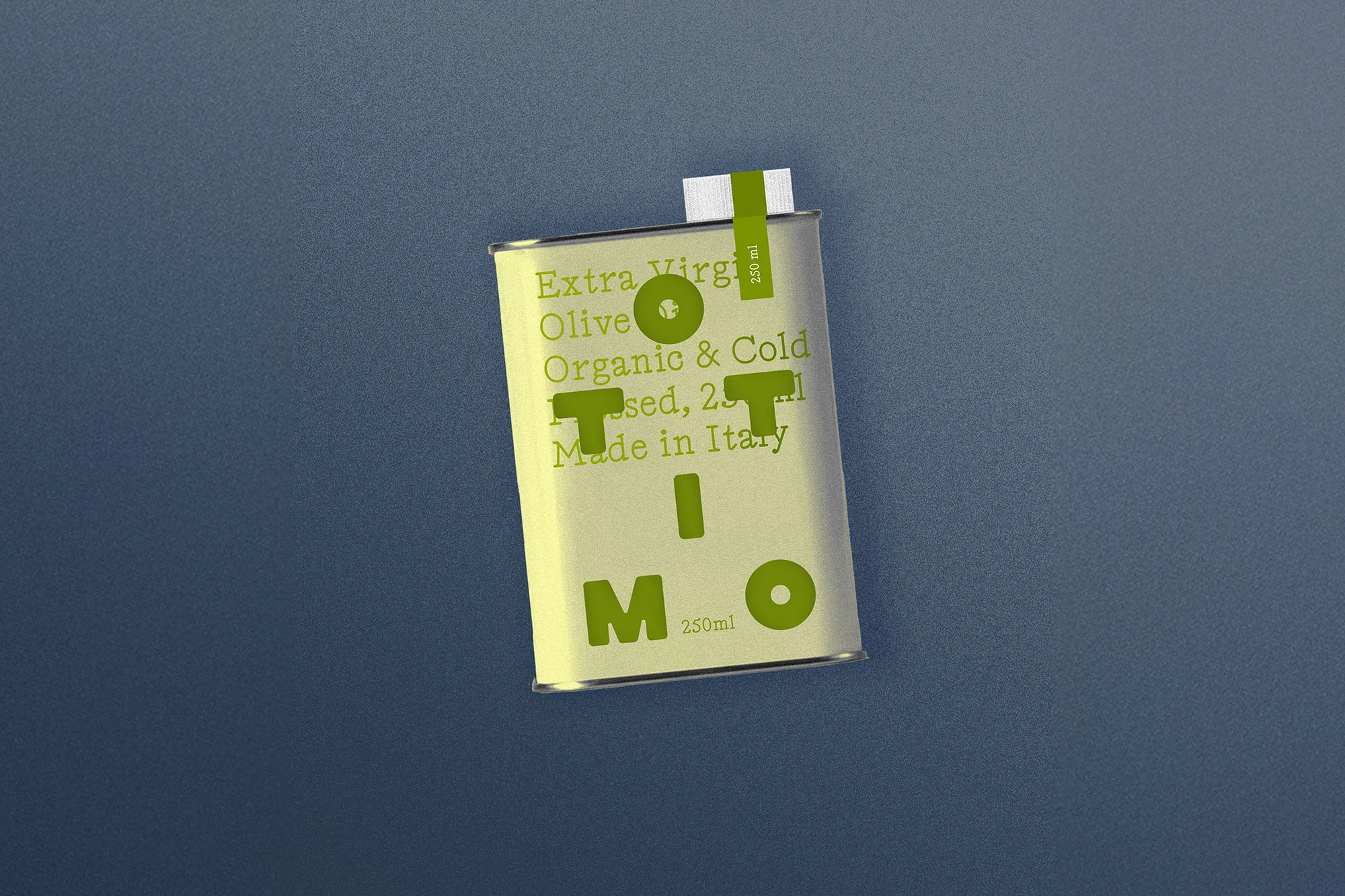 Olive oil tin can on a textured blue surface with a simple label design featuring green text. The can has a minimalist aesthetic.