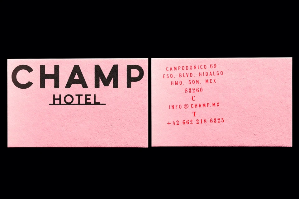 Two business cards for Champ Hotel in pink and black with contact information and hotel name. Stationery and hotel business promotion.