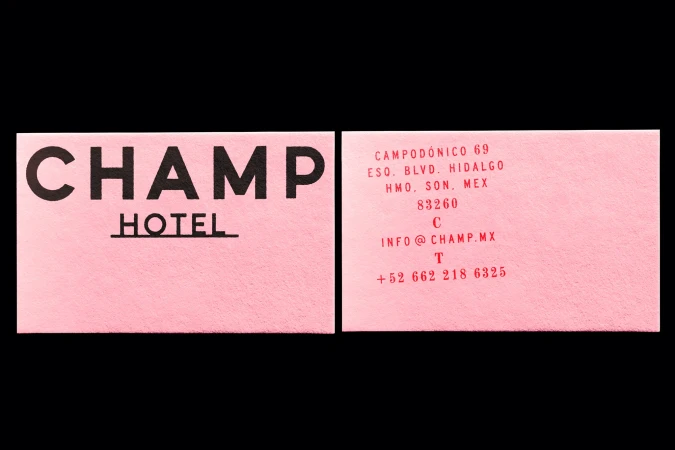 Two business cards for Champ Hotel in pink and black with contact information and hotel name. Stationery and hotel business promotion.