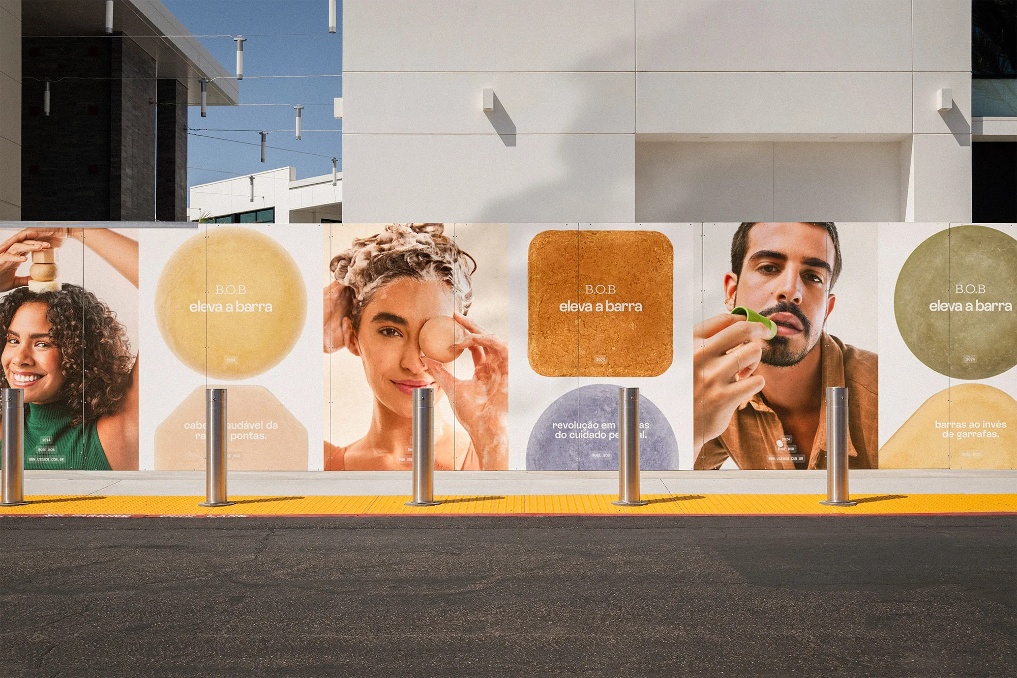Outdoor marketing installation featuring portraits and branding for B.O.B. hair and beauty products against a commercial building facade.