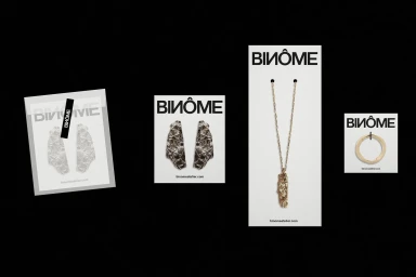 Minimalist graphic design and packaging layout for brand identity featuring textured metallic jewelry items on white display cards against a black background.