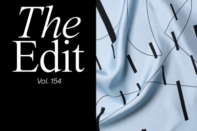 Light blue silk fabric with black abstract linear patterns next to a black panel featuring white serif typography reading The Edit Vol 154.