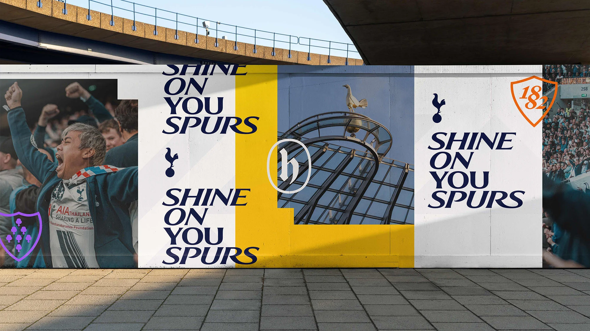 Outdoor mural displays enthusiastic soccer fans, building architecture, logos, and text: SHINE ON YOU SPURS.