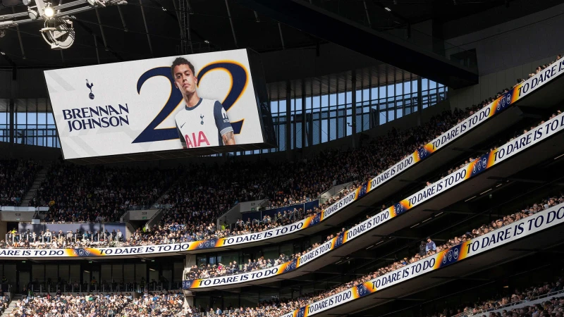 Soccer stadium view of a digital screen displaying soccer player Brennan Johnson with the Tottenham Hotspur logo and '22' on it.