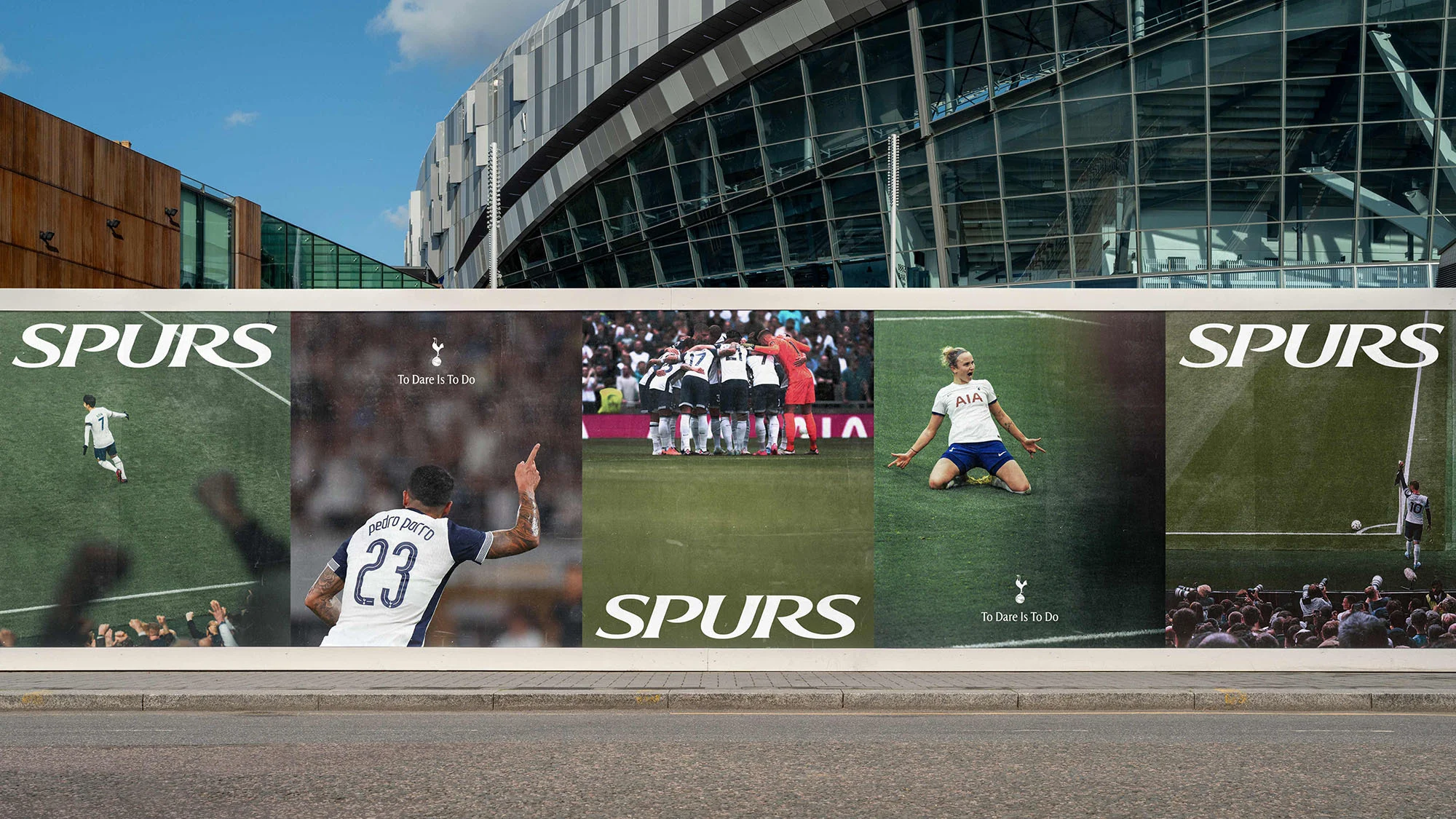 Outdoor billboard featuring soccer players and Spurs branding set against a modern stadium, capturing a dynamic sports advertisement.