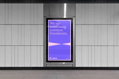 Vertical digital billboard displaying purple poster with white typography mounted on grey tiled wall