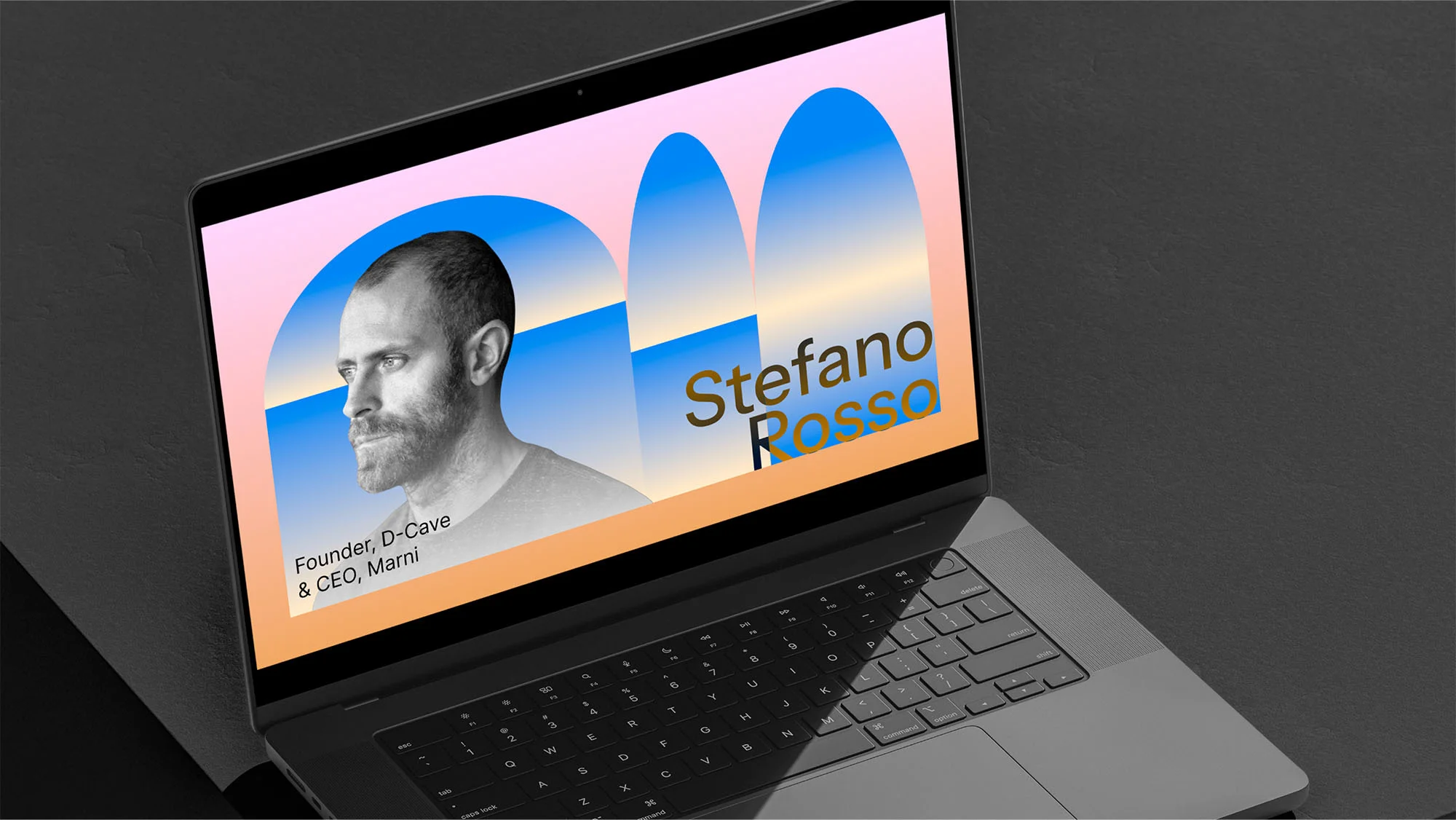 Laptop screen displays Stefano Rosso's monochrome portrait, name in gold, and company details against geometric shapes in peach and blue tones.