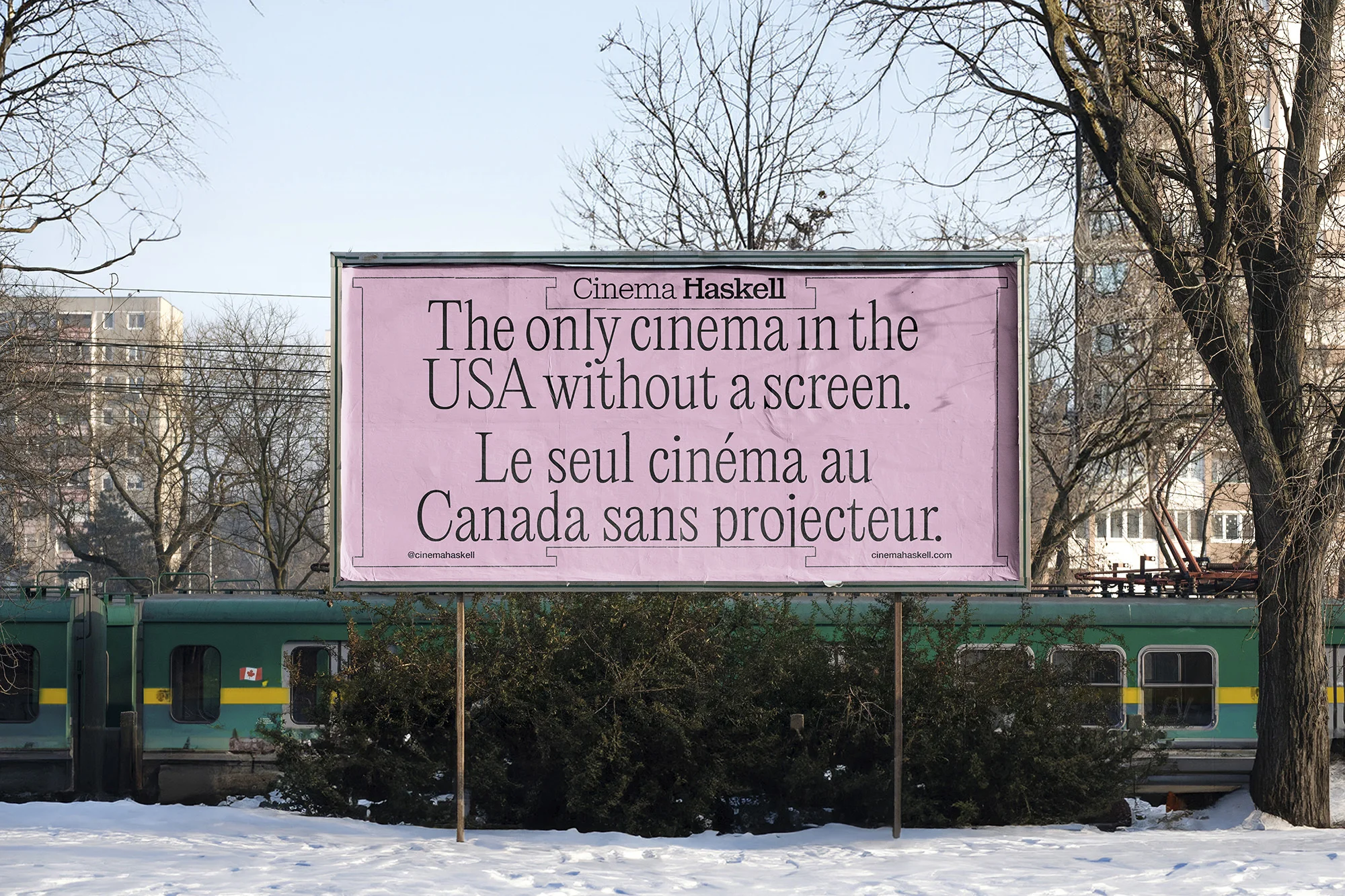 Billboard advertisement for Cinema Haskell, "The only cinema in the USA without a screen", displayed outdoors in a snowy environment.