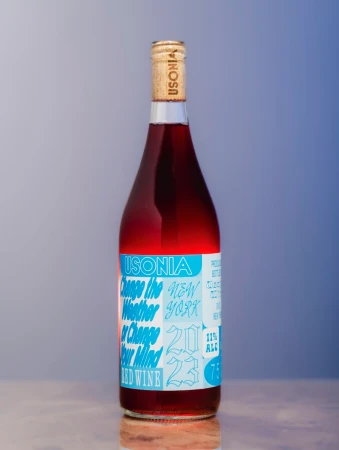 Studio shot of a single bottle of Usonia red wine with a bright blue label against a blurred background, product photography.
