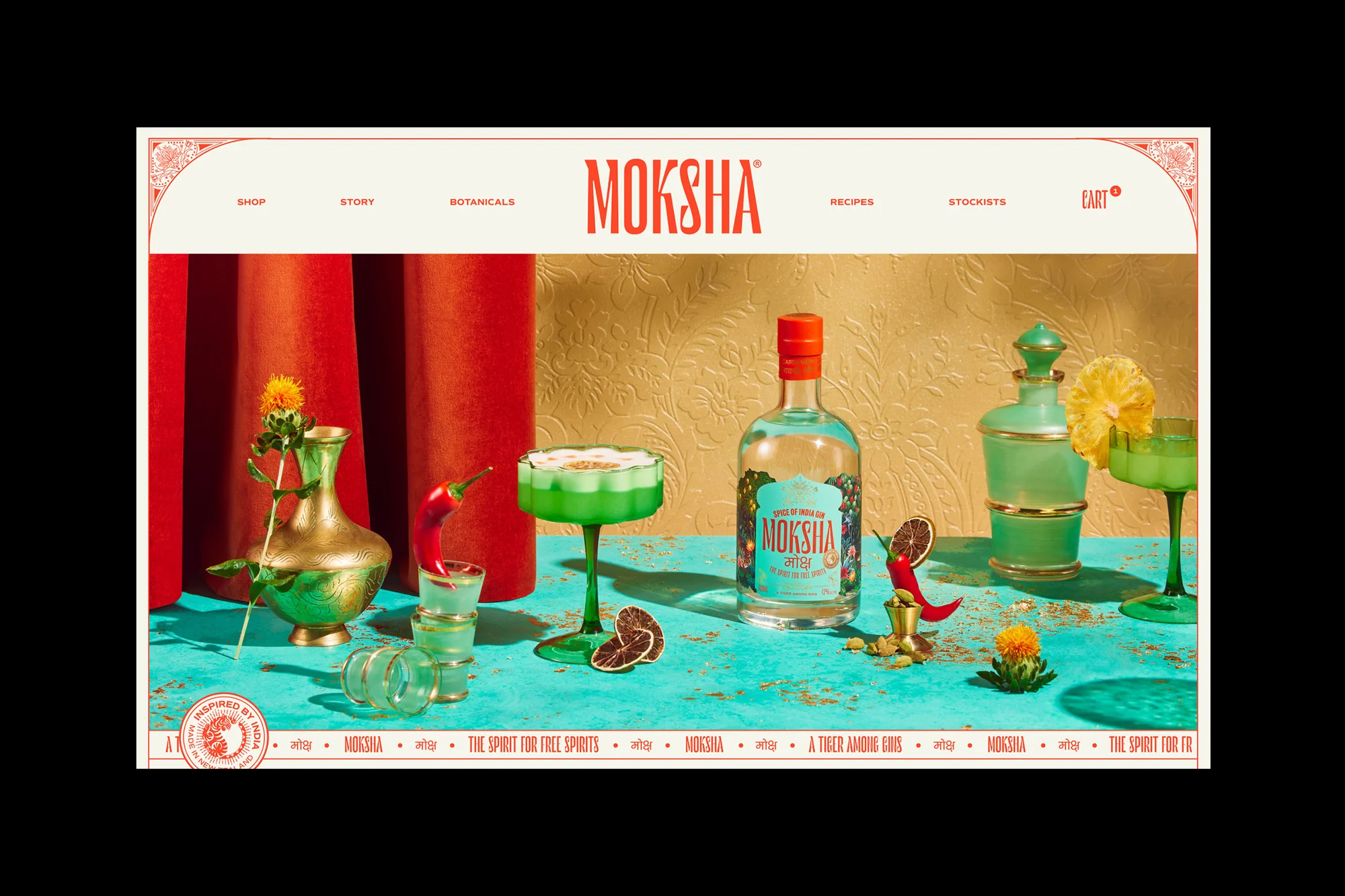 Moksha gin bottle and cocktails are displayed with flowers, spices, and fruits on a turquoise surface, with red curtains in the background.