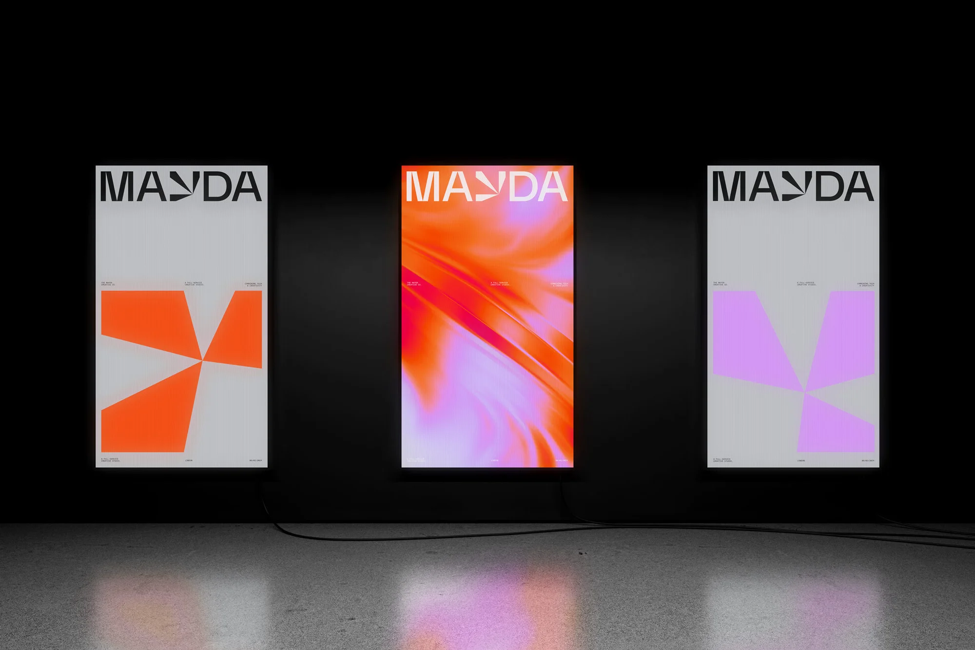 Three MAYDA posters in a row, one orange graphic, one pink and orange abstract, one violet graphic, modern art in gallery space.