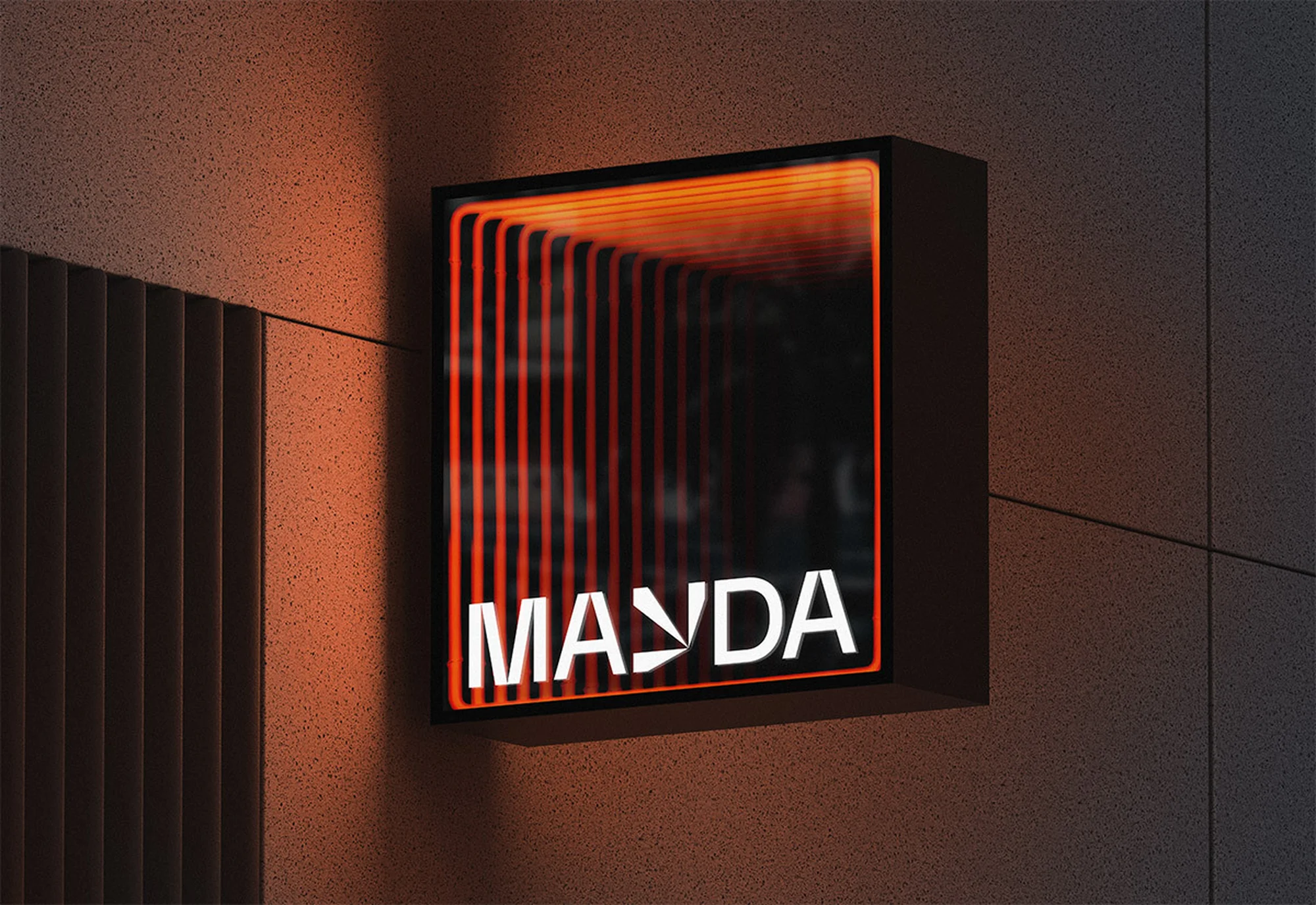 Illuminated sign displays the text 'MAYDA' in white with graphic design elements, mounted on a textured wall with vertical paneling.